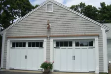 Garage doors with decorative hardware