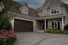 Traditional 2-stories house. Garage door is a North Hatley LP, 16' x 8', Moka Brown color, 4 vertical lite Orion windows