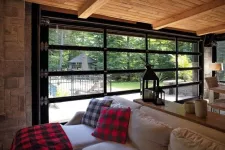 This full-view California garage door between the living room and the outside swimming pool creates a wonderful indoor / outdoor space.