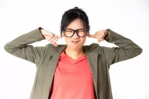 Girl blocking noise with her hands
